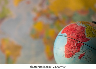 Africa map on a globe with earth map in the background.