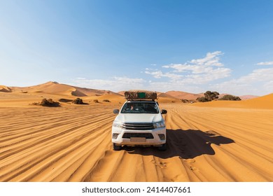 Africa- namibia- namib desert- naukluft national park- off-road vehicle on sand track - Powered by Shutterstock