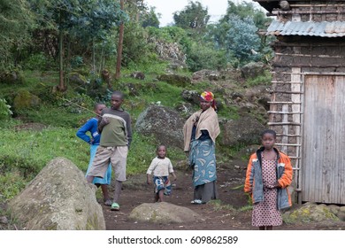 Africa, Rwanda, Musanze District,Volcanoes National Park, Ruhengeri, Kinigi.  Local Villagers By Their House. 2016-08-04