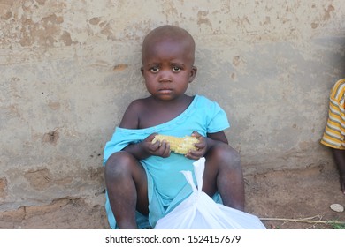 Africa, Uganda, 15.04.2019 Sad Black Boy With Corn In The Hands