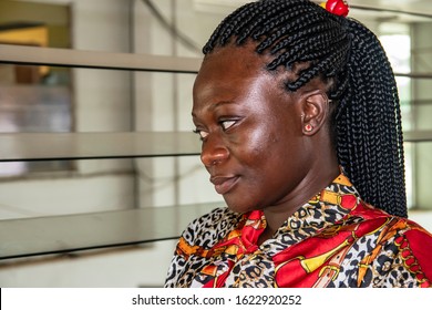 Africa Woman Sitting At A Bus Station Waiting For Her Bus. Location Accra Ghana West Africa