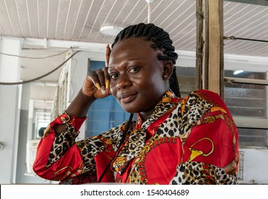 Africa Woman Sitting And Waiting In A Bus Station In Accra Ghana.