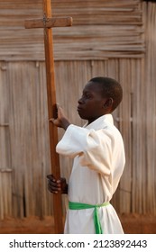 African altar boy carrying a cross. Catholic church.   Togo.  06-30-2014