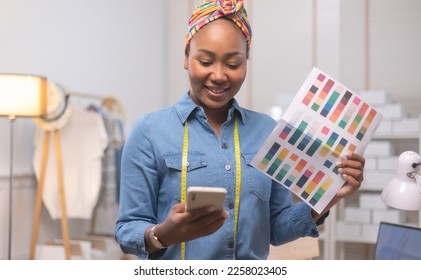 African american adult female woman fashion designer cloth tailor creative working for new collection.Happy online store owner preparing an order for shipping . - Shutterstock ID 2258023405