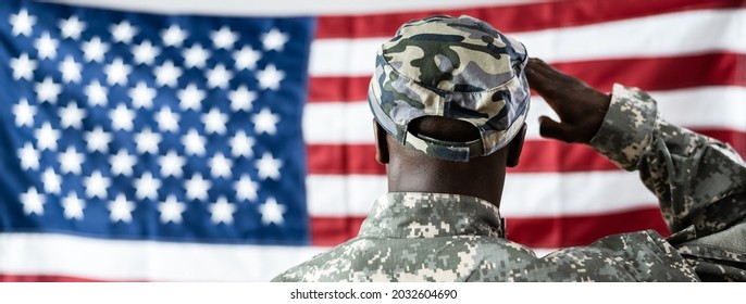 African American Army Soldier Saluting In Front Of American Flag