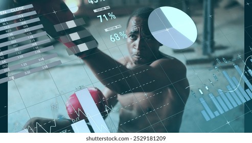 African American athlete training with boxing gloves, digital graphs overlaying. He has short black hair, focused eyes, wearing sleeveless shirt - Powered by Shutterstock