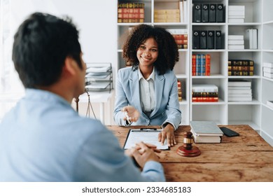 african american attorney, lawyers discussing contract or business agreement at law firm office, Business people making deal document legal, justice advice service concepts. - Shutterstock ID 2334685183