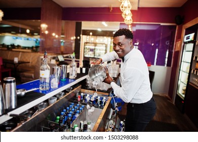 African American Bartender At Bar With Ice Bucket. Alcoholic Beverage Preparation.