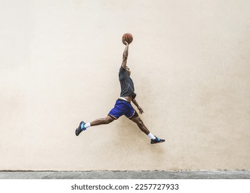 African american basketball player training on a court in New York - Sportive man playing basket outdoors - Powered by Shutterstock