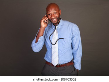 African American / Black Doctor Checking His Cell Phone