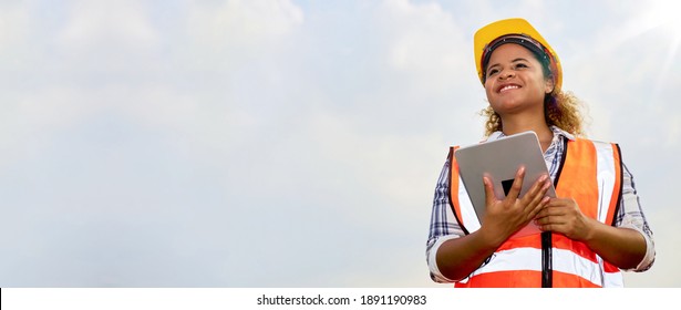 African American Black Female Engineer Or Architect Stands Outdoors With Tablet.