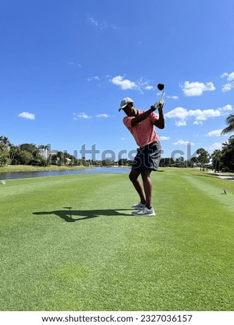 African American, Black left-handed golfer on beautiful country club golf course 