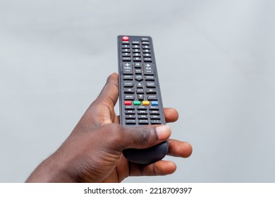 African American Black Man Hand Holding TV Remote Control Blank Isolated On A White Background.