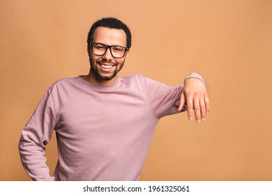 African american black man leaning on something imaginary - isolated over beige background. Copyspace for text.