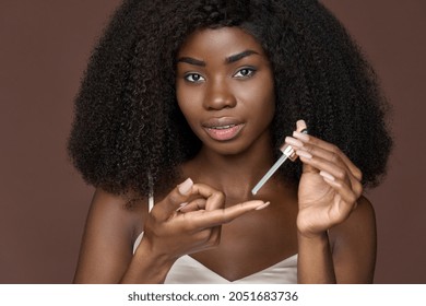 African American Black Woman Putting Applying On Finger Facial Hyaluronic Acid Regenerating Anti Acne Rejuvenating Serum Skin Treatment Doing Daily Routine. Skincare Youthfulness Concept. Close Up.