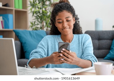 African American Black Woman Working And Using Smartphone Home