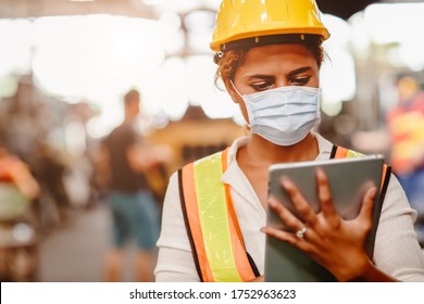 African American Black Women Teen Worker Wearing Face Shield Or Disposable Face Mask During Working In Factory For Prevent Spreading Of Coronavirus(Covid-19) And Air Dust Pollution For Labor Healthy.