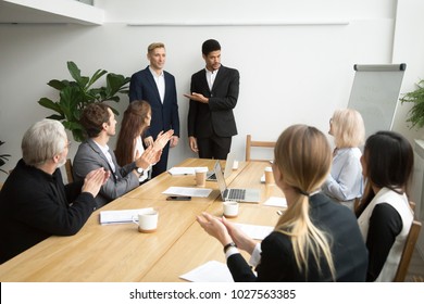 African American Boss Or Black Hr Executive Ceo Introducing New Hire Employee To Corporate Team Applauding At Group Meeting, Office Workers Clapping Hands Welcoming Coworker With Friendly Ovation