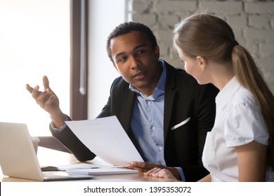 African american boss negotiating discussing contract details with company corporate woman client. Black hr manager interviewing young female job candidate. Employment hiring human resources concept