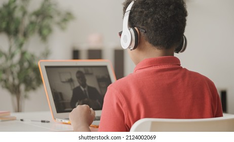 African American Boy In Headphones Learning Foreign Language Online With Tutor