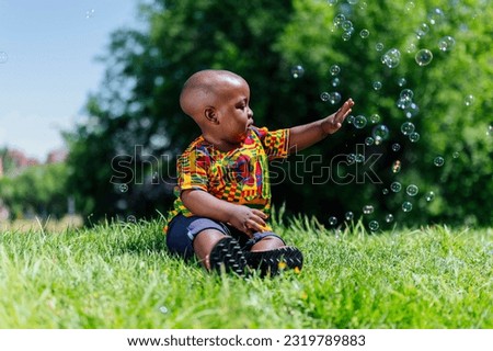 African American boy playing with soap bubbles