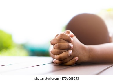 African American Boy Praying At Home.coronavirus Covid-19.Stay At Home Praying To GOD.Online Church Worship In Sunday.black Boy Child Hand Praying At Home.Social Distancing.No Racism.Pray For America.