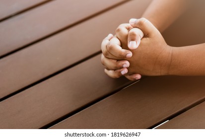 African american boy praying at home.coronavirus Covid-19.Stay at home praying to GOD.Online church worship in sunday.black boy child hand praying at home.Social distancing.No racism.Pray for america.