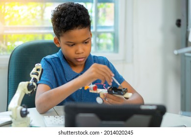 African American Boy Setting Robot Kit In Science Classroom
