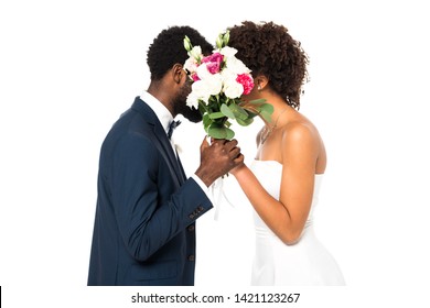 Slicked Up Flower Vase african american bride and bridegroom covering faces while holding flowers isolated on white