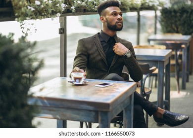 African American Business Man In A Cafe Drinking Coffee