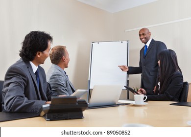 An African American Business Man Giving A Presentation To Associates