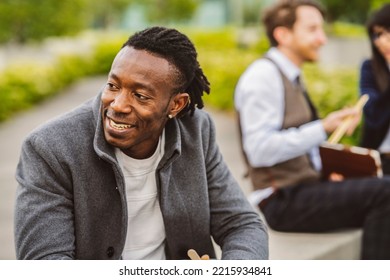 African American Business Man Outdoors Sitting On City Park Bench On Urban Street Background.