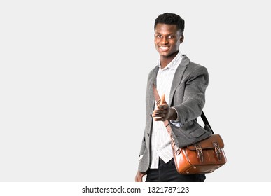 African american business man traveling with suitcases shaking hands for closing a good deal on isolated grey background