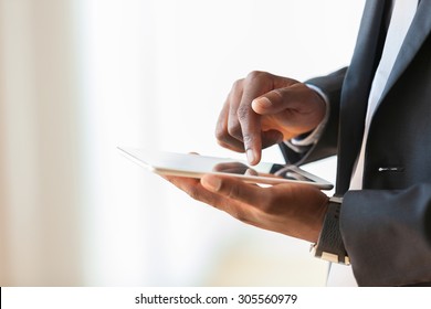 African American Business Man Using A Tactile Tablet Over White Background - Black People