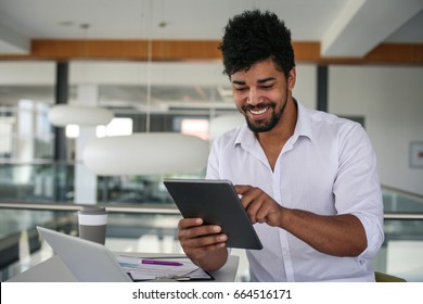 African American Business Man Using Digital Tablet At The Office. African Man Working On Tablet.