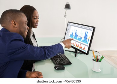African American Business Man And Woman Showing Their Successful Teamwork On Computer