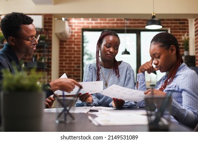 African american business people discussing financial strategy while in workspace. Company office employees cooperating regarding startup project marketing expenses while in modern office interior. - Shutterstock ID 2149531089