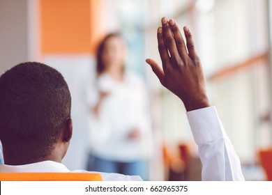 African american Business people Raising there Hand Up at a Conference to answer a question
