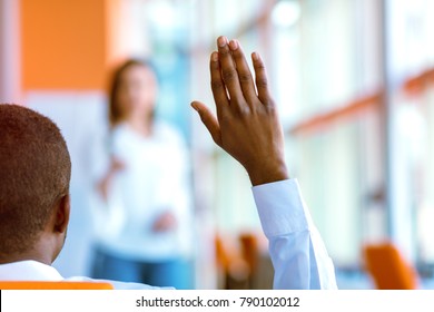 African American Business People Raising There Hand Up At A Conference To Answer A Question