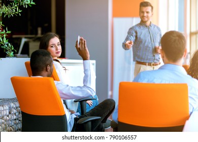 African American Business People Raising There Hand Up At A Conference To Answer A Question