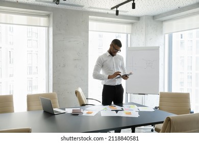 African American business project leader using online app on tablet for effective scrum paperwork, reviewing, analyzing reports, working on project with documents, consulting internet - Shutterstock ID 2118840581