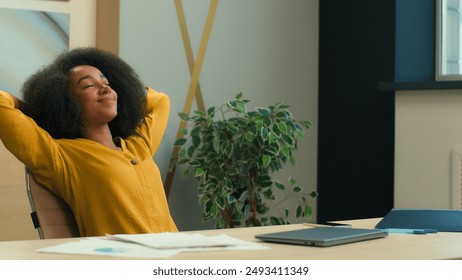 African American business woman businesswoman girl female office manager with laptop at office satisfied relaxed stretching at chair relax rest put hands behind head relaxing accomplish work end smile - Powered by Shutterstock