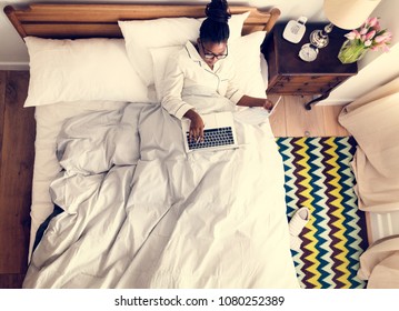 African American Business Woman On Bed Working