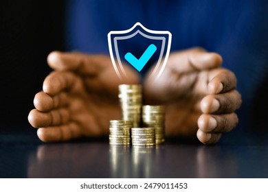 African American businessman counting coins to protect income and invest in long-term success. Professional finance manager securing his capital. - Powered by Shutterstock