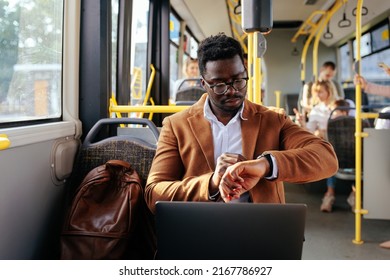 African American Businessman In Elegant Suit Traveling By Bus To Work And Checking Time On His Watch