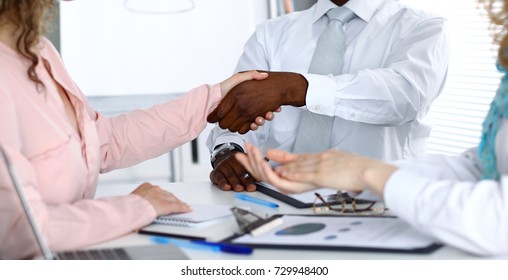 African american businessman shaking hands with female partner in office - Shutterstock ID 729948400