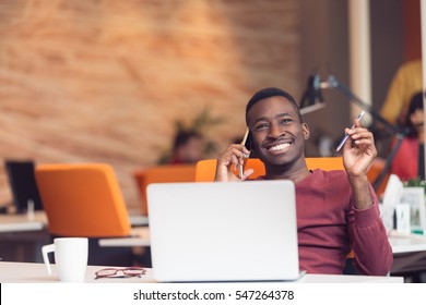 African American businessman sitting at the computer in startup office