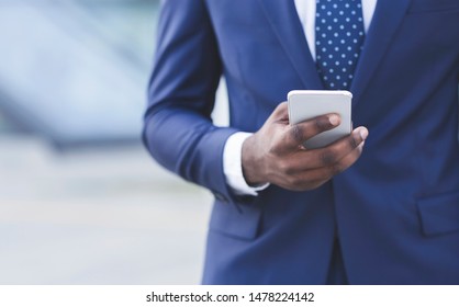 African American Businessman Texting On Smartphone In City. Empty Space For Text, Closeup, Cropped - Powered by Shutterstock