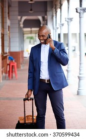 African American Businessman Traveling With Bag And Talking On Mobile Phone 