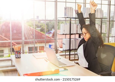 African American Businesswoman Get Work Done Time Is Running Out Or The Job Is Done. Raise Both Hands In The Air She Works At The Company Office. Finish Work And It's Time To Go Home And Rest.